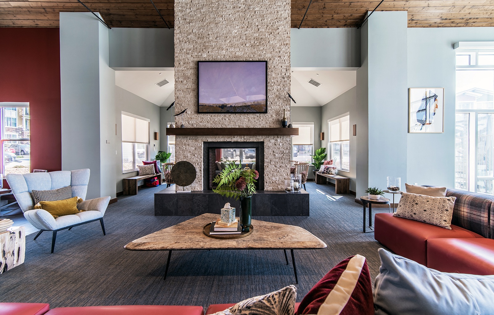 a large living room with couches and a fireplace